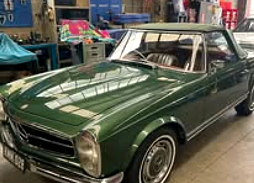 A green Mercedes-Benz Pagoda on the bench