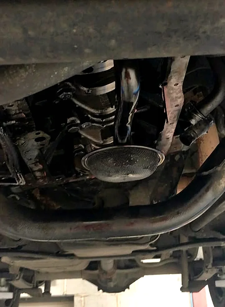 A classic car up on the hoist